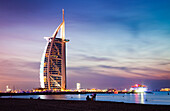 The world's first seven stars luxury hotel Burj Al Arab at night seen from Jumeirah public beach in Dubai, United Arab Emirates