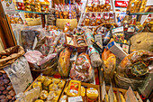 View of food shop window on via Roma at dusk, Courmayeur, Aosta Valley, Italy