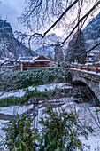 View of hotels and lodges with mountains in background during winter, Courmayeur, Aosta Valley, Italy
