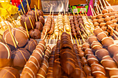 View of market stall with fruit covered in chocolate at Christmas, Breitscheidplatz, Berlin, Germany