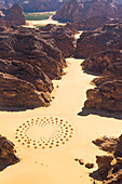Aerial view of a work of land art in the middle of red sandstone formation, in the area of AlUla, Medina Province, Saudi Arabia