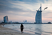 The world's first seven star luxury hotel Burj Al Arab at sunset seen from Jumeirah public beach, Dubai, United Arab Emirates