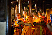 Makha Bucha (Magha Puja) celebrations, monks pray under illuminated Buddha statue annually at Wat Phan Tao temple, Chiangmai, Thailand