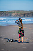 Young woman training strength and mobility on the beach of Baleal Island