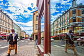 Oslo, Norway, Aug 10 2017, A Muslim woman dressed in traditional attire walks past cafes and shops on a sunny day in the trendy Grunerlokka neighborhood of Oslo.