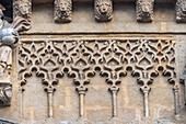 Intricate lion head carvings and sekba designs adorn the facade of San Marcos church, showcasing mudéjar architectural style in Seville.