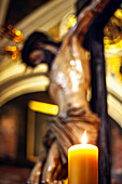Seville, Spain, Feb 26 2018, Cristo del Calvario illuminated by a candle in Magdalena church, Seville, capturing a moment of deep devotion.