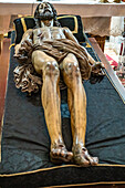 Seville, Spain, Apr 11 2017, Wooden sculpture of Cristo Yacente by Juan de Mesa in Spanish church setting.