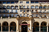 El Mercado del Arenal showcases Andalusian architecture with arched entrances and balconies in Seville, highlighting its historical charm.