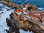 Aerial view of Vestigios do Forte, the rocky cliffs of Baleal Island and local architecture, Portugal