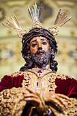 In Seville, a Baroque sculpture of Nuestro Padre Jesus de la Sentencia showcases devotion and artistry during Holy Week.