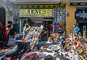 Detailed antique booth at El Jueves flea market in bustling Seville, Spain