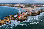 Aerial view of Vestigios do Forte, the rocky cliffs of Baleal Island and local architecture, Portugal