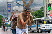 A man in a representation of Jesus Christ crosses a crosswalk on a street in Caracas.