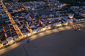 Aerial view of Nazare beach and cityscape at night, Portugal