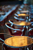 A scenic view of café tables reflecting morning light in Plaza Mayor, Salamanca.