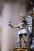 Archangel Raphael stands adorned with grace, watching over the float of Cristo de Pasión in Seville as part of Holy Week celebrations.