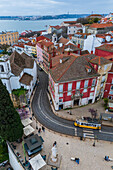 Aerial view of traditional yellow tram in the streets of Alfama, Lisbon, Portugal