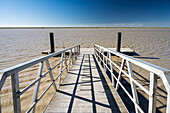 Visitors can enjoy the serene ambiance at the pier overlooking the muddy waters of the Lower Guadalquivir in Trebujena, Spain.