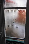 'I love Lisbon' hand written on a wet window in Alfama