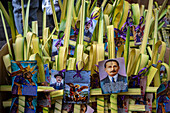 Palm Sunday palms are offered for sale with images of the Nazarene and Blessed Jose Gregorio Hernandez.