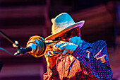 Sanlucar de Barrameda, Spain, Jul 17 2004, Jerry Gonzalez passionately plays muted trumpet during a live concert under colorful lights.