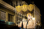 Seville, Spain, Apr 11 2017, Holy Week religious procession featuring a statue of Virgen de las Aguas under an ornate canopy.