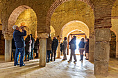 Almonaster, Spain, March 2nd 2013, Tourists admire the stunning architecture of the 9th century mosque in Almonaster la Real, Huelva, Andalucía during their visit.