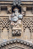 Stunning statuary of God is adorned with sekba decorations on the facade of the historic church of San Marcos in Seville.