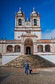 Father and son walking to Sanctuary of Our Lady of Nazareth - Santuario de Nossa Senhora da Nazare -, Portugal