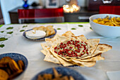 Decorative table prepared for a Christmas meal featuring various appetizers and festive touches, creating a warm holiday atmosphere.