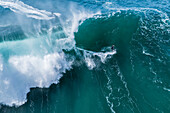 Aerial drone view of Big wave surfing in Praia do Norte (North Beach), listed on the Guinness World Records for the biggest waves ever surfed, formed under the influence of the Nazare Canyon, Portugal