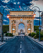 Montpellier, France, Aug 18 2022, Montpellier's Triumphal Arch, designed by François D'Orbay in 1692, stands proudly against a dramatic sky, marking a historic landmark.
