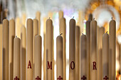 Candles on Virgen del Socorro's paso de palio showcase 'Amor' during Seville's Holy Week celebrations.