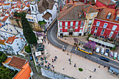 Aerial view of traditional yellow tram in the streets of Alfama, Lisbon, Portugal