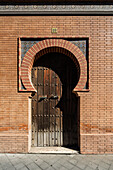 Explore the intricate door design of the Catalana de Electricidad building in Seville, showcasing Neomudéjar architecture from 1910.