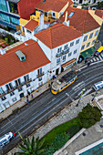 Aerial view of traditional yellow tram in the streets of Alfama, Lisbon, Portugal