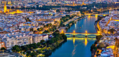 A beautiful aerial view of Seville, showcasing key landmarks in the evening lights.