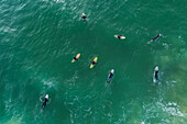 Aerial view of surfers in the water waiting for the right wave in Baleal Island beach