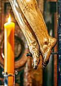 the feet of Cristo del Calvario in Seville's Magdalena church during a spiritual moment.