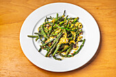 Exquisite Spanish asparagus dish presented beautifully on a white plate, freshly prepared.