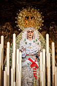 Virgen de la Esperanza Macarena, crowned and graceful, stands ready on her paso for the Good Friday procession in Seville, Andalusia.
