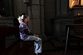 A woman prays in a church in Caracas during Holy Week.