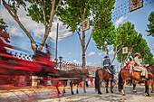 Seville, Spain, Apr 29 2009, Joyful riders and vibrant carriages flow through the lively April's Fairgrounds under a bright sky in Seville, Andalusia.