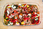 Vibrant roasted red pepper and tuna salad complemented by boiled eggs and fresh chives.