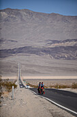 Two cycle tourists on a lonely road in the area of Death Valley, California