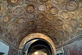 Bas relief ceiling of the vestibule of the Stabian Baths, Building VII.1.8, in the ancient Roman ruins of Pompeii, Italy.