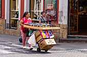 A woman selling sunglasses on the street in Salta, Argentina.