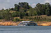 A large tour boat from the Hotel Los Recuerdos on the Embalse Del Peñol or Guatape-Penol Reservoir in Colombia. The boat is also a floating restaurant.