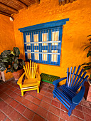 Colorful painted Adirondack chairs on the patio of the Cafe La Manchuria in Peñalisa, Colombia.